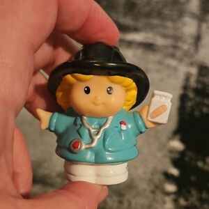 Fisher-Price Little People figure, specifically identified as a paramedic, EMT,